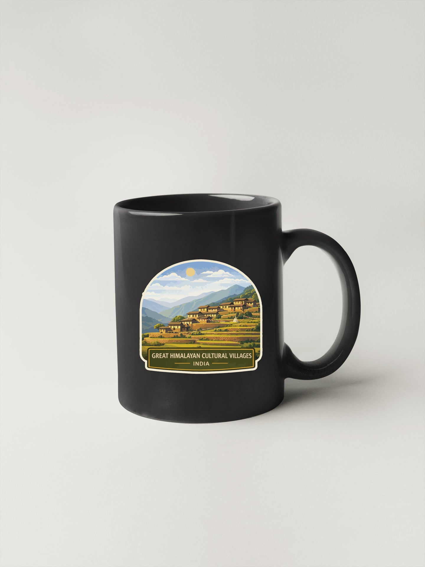 A black coffee mug with a printed image of a village in the Himalayan region, along with the text "Great Himalayan Cultural Villages India".