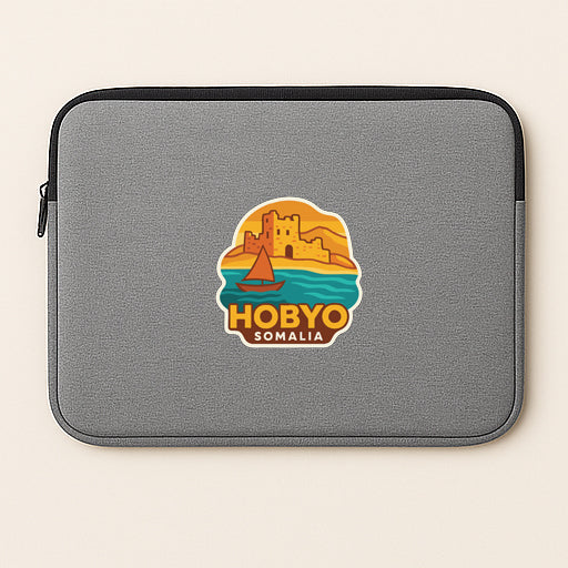 A gray laptop sleeve with a graphic design featuring a sailboat and a castle, along with the text "HOBBYO SOMALIA".