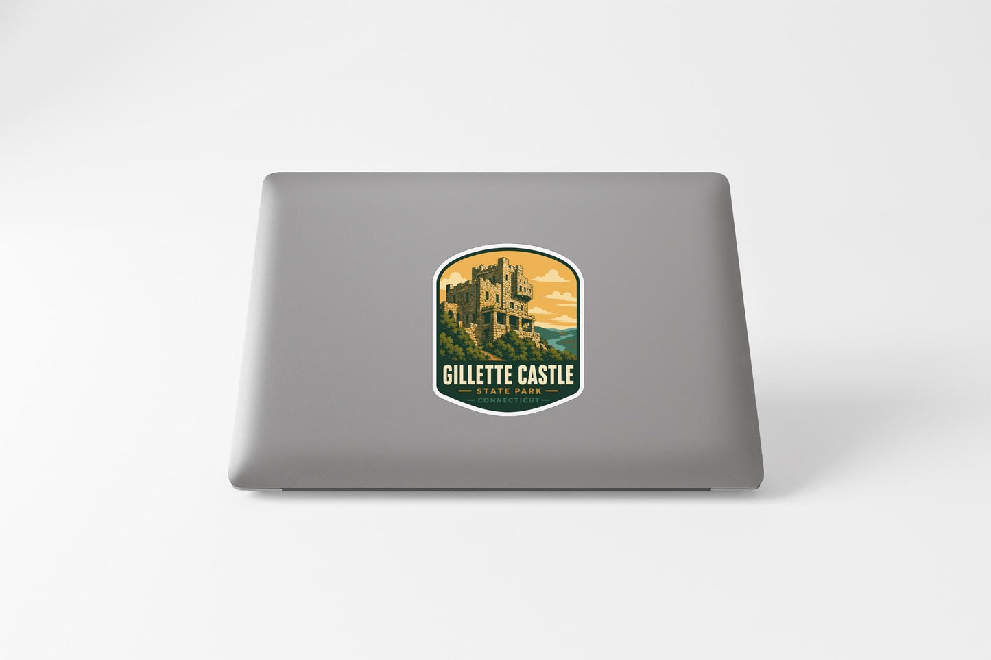 a sticker with a castle on it, placed on the back of a laptop.