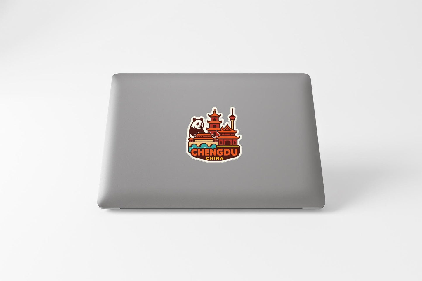 A sticker on the back of a laptop displaying the name of a city, which is Chengdu, China.