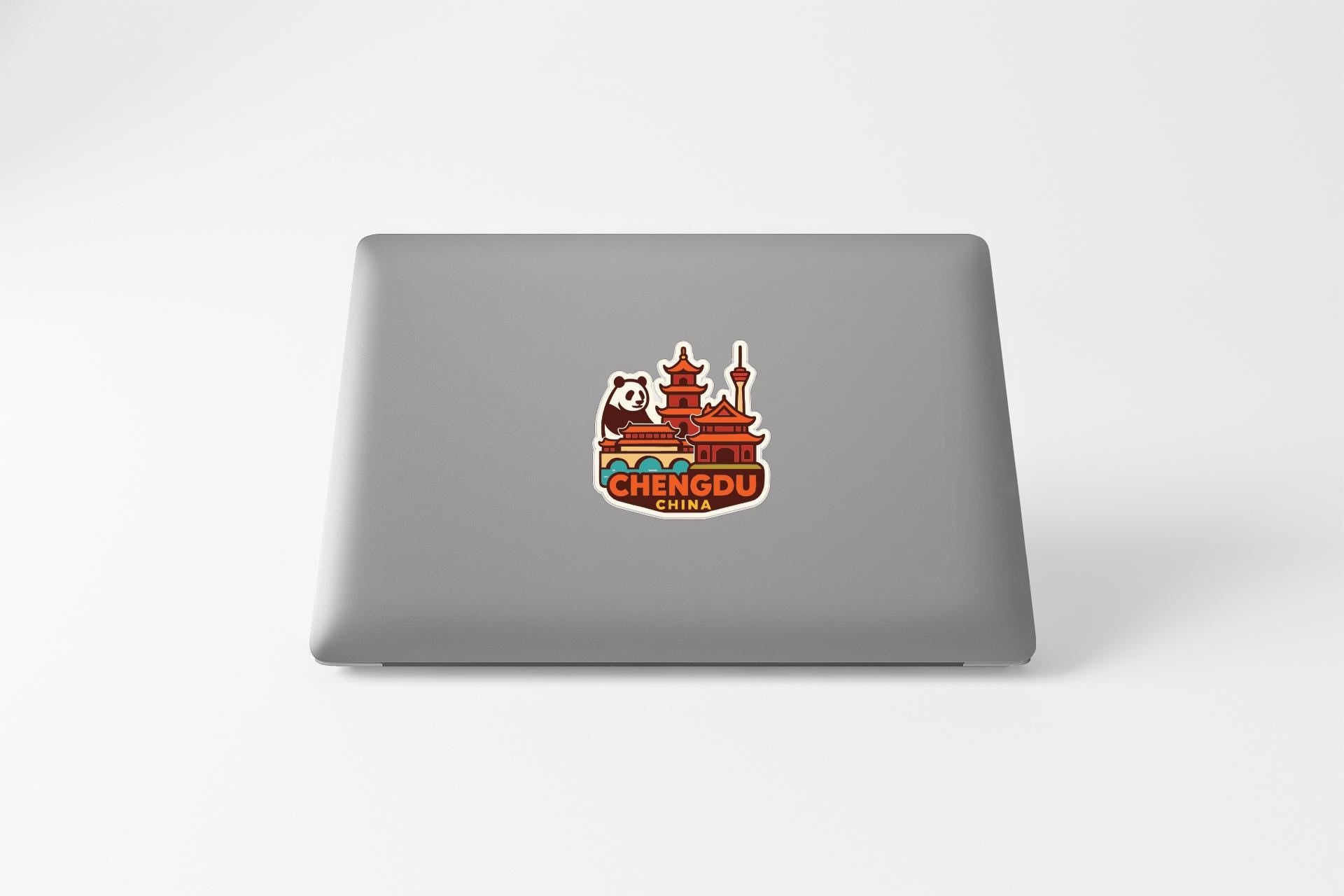 A sticker on the back of a laptop displaying the name of a city, which is Chengdu, China.