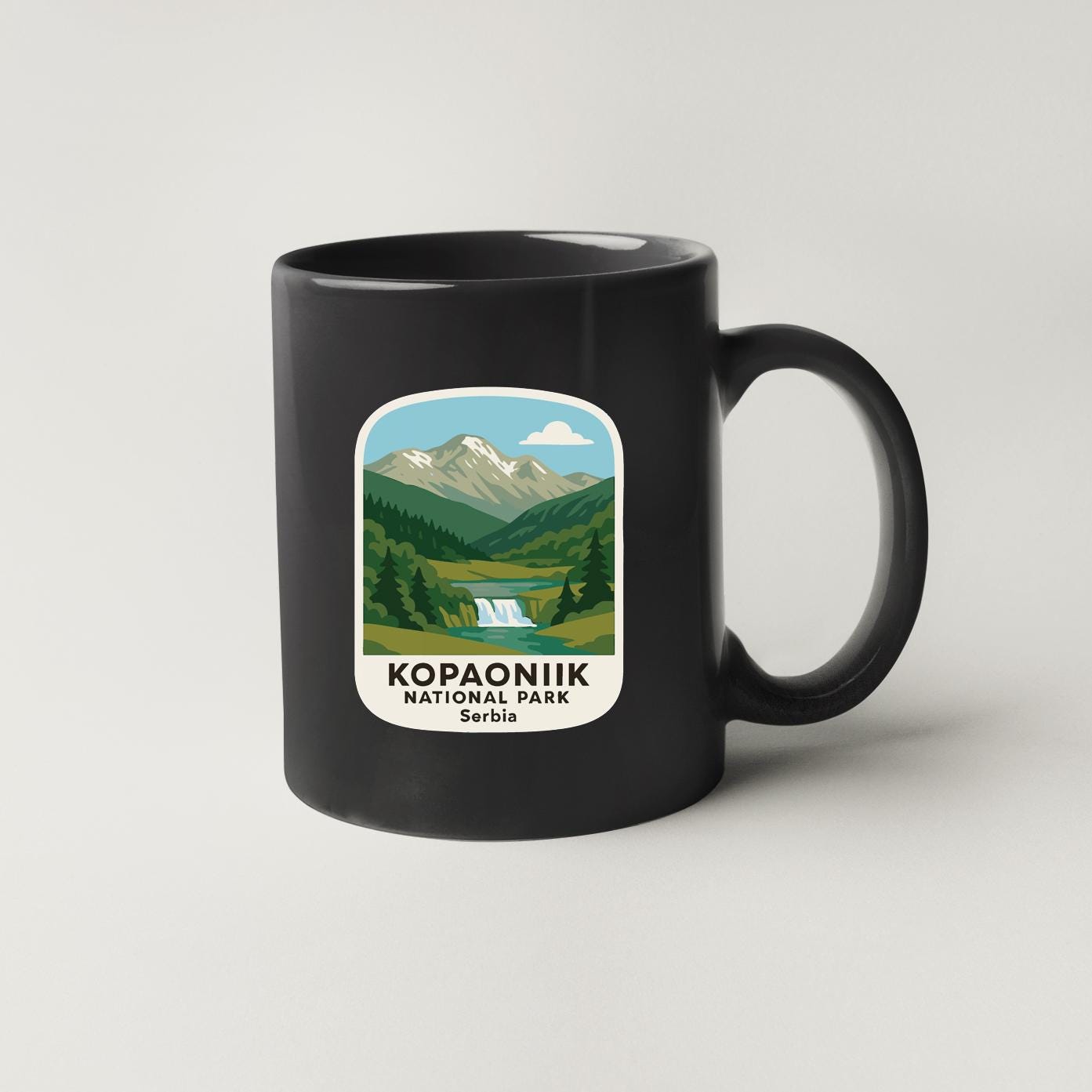 A black coffee mug with a label that says "Kopaonik National Park Serbia".