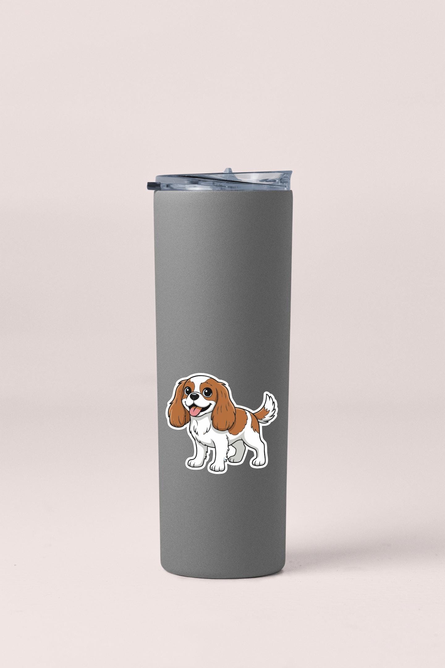 A gray insulated tumbler with a cartoon illustration of a dog on it.