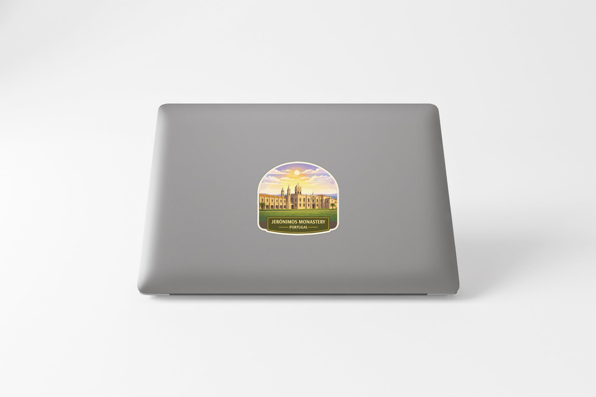 a sticker with a castle and a sunset on a laptop.