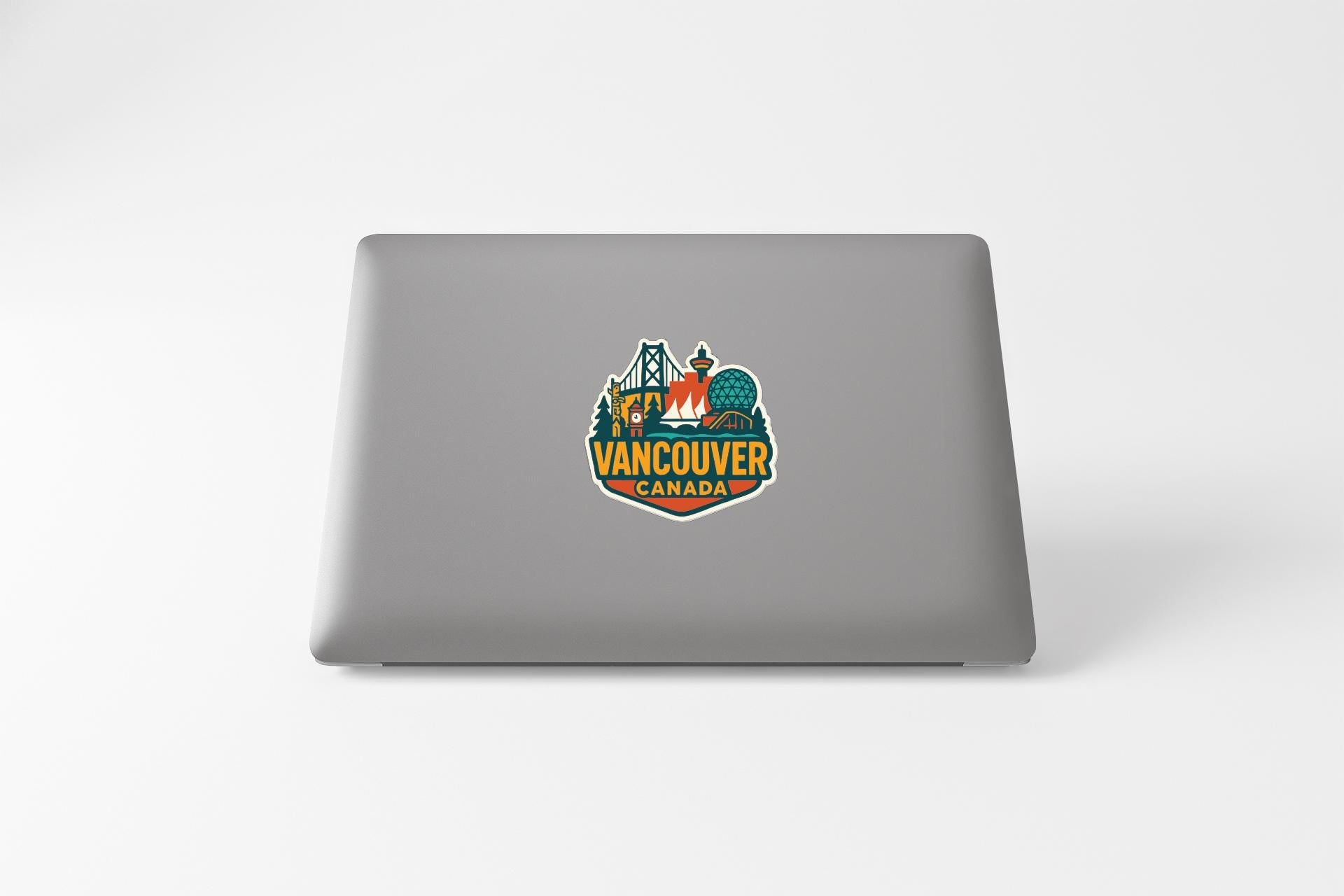 a sticker on the back of a laptop that says "Vancouver Canada".
