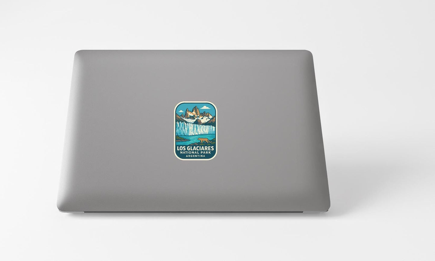 A sticker on the back of a laptop, depicting a scenic landscape with mountains and a body of water.
