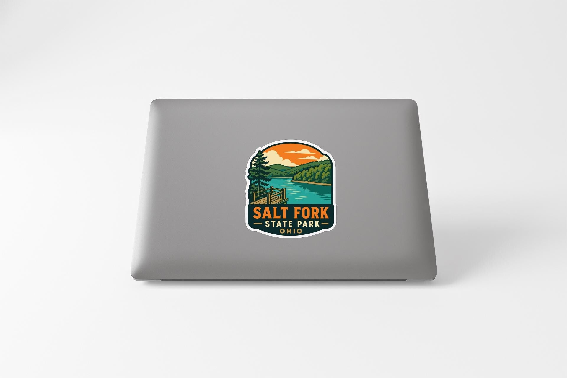 a sticker with a scenic landscape and the text "Salt Fork State Park" on a laptop.