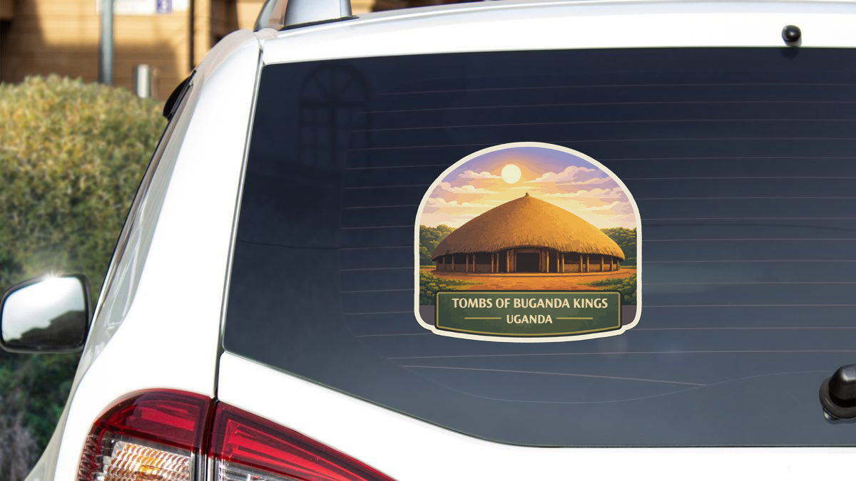A sticker on the rear window of a car, depicting a thatched-roof hut with a sunset in the background.