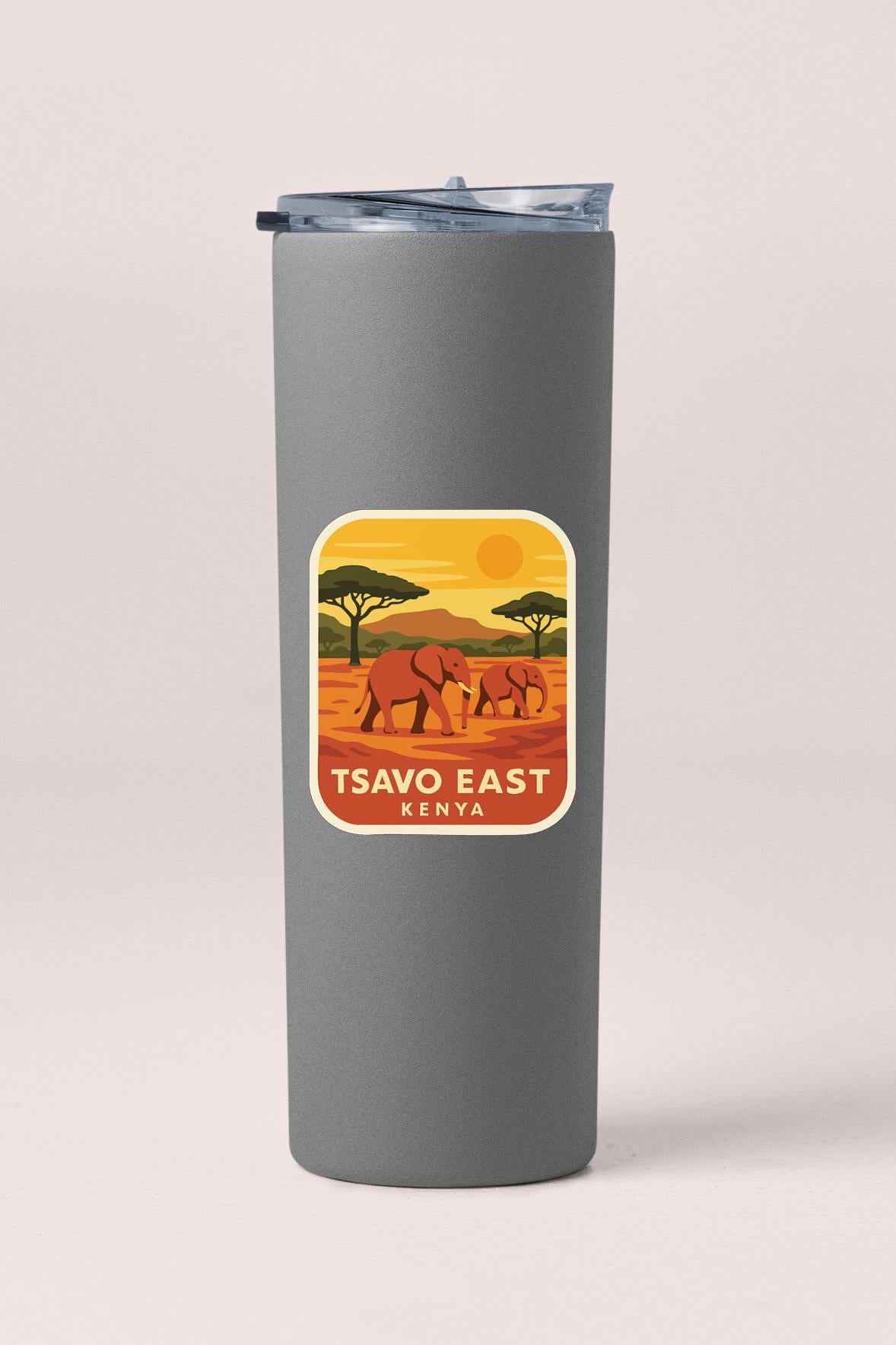 A gray tumbler with a sticker depicting an illustration of elephants in a savanna landscape, along with the text "TSAVO EAST KENYA".