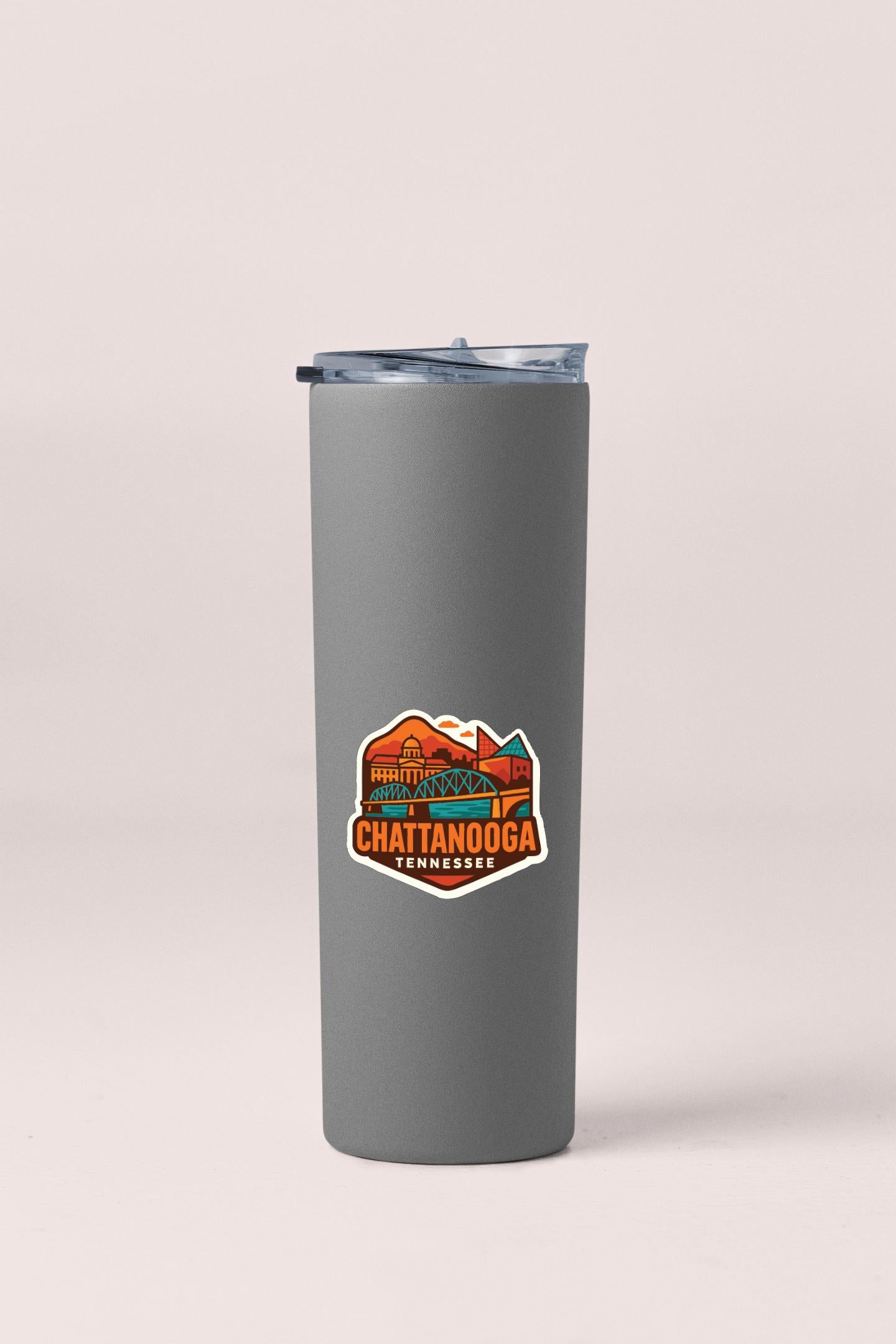 A gray insulated tumbler with a sticker depicting the scenic city of Chattanooga, Tennessee.