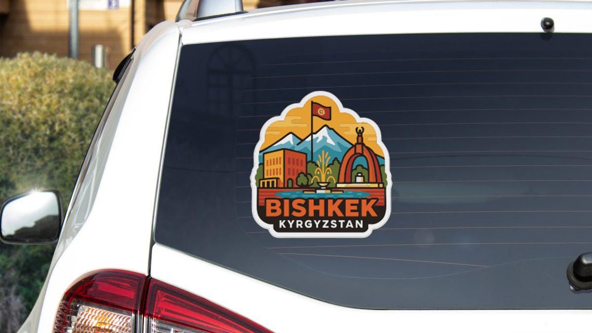 a sticker on the rear window of a white car, depicting a scenic landscape with mountains, buildings, and a flag.