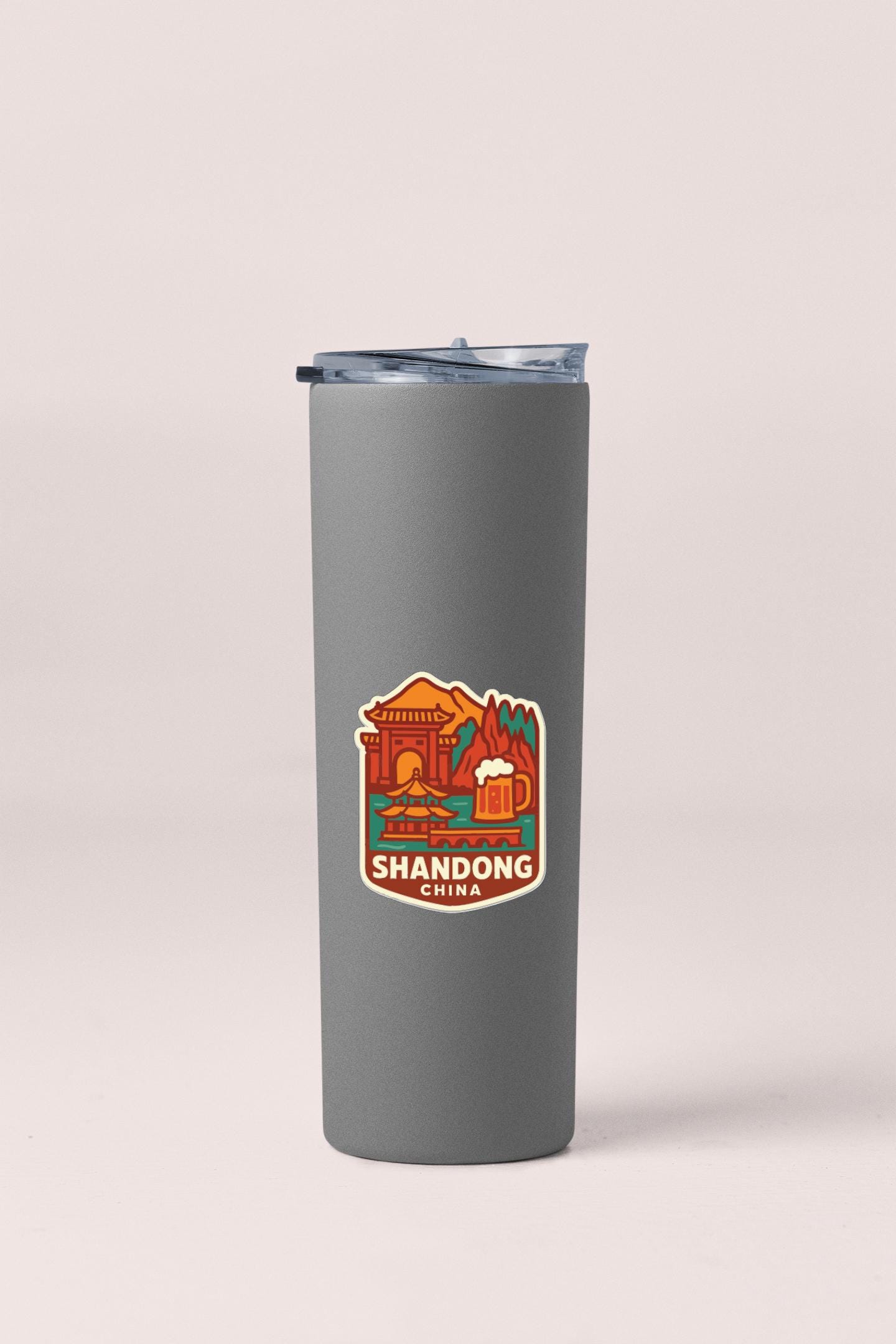 A gray insulated tumbler with a sticker depicting Shandong, China.