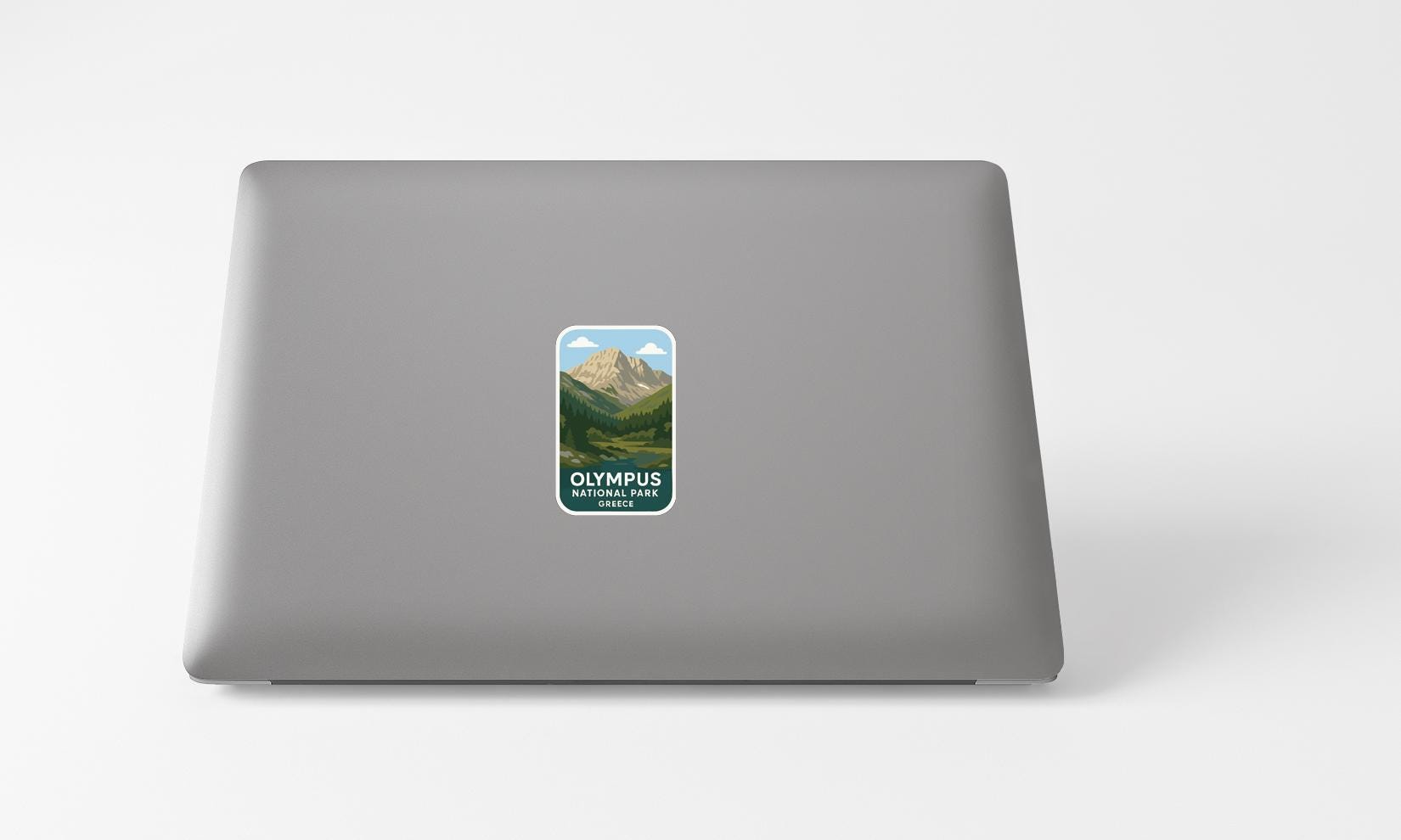 A sticker with a mountain landscape on a laptop.