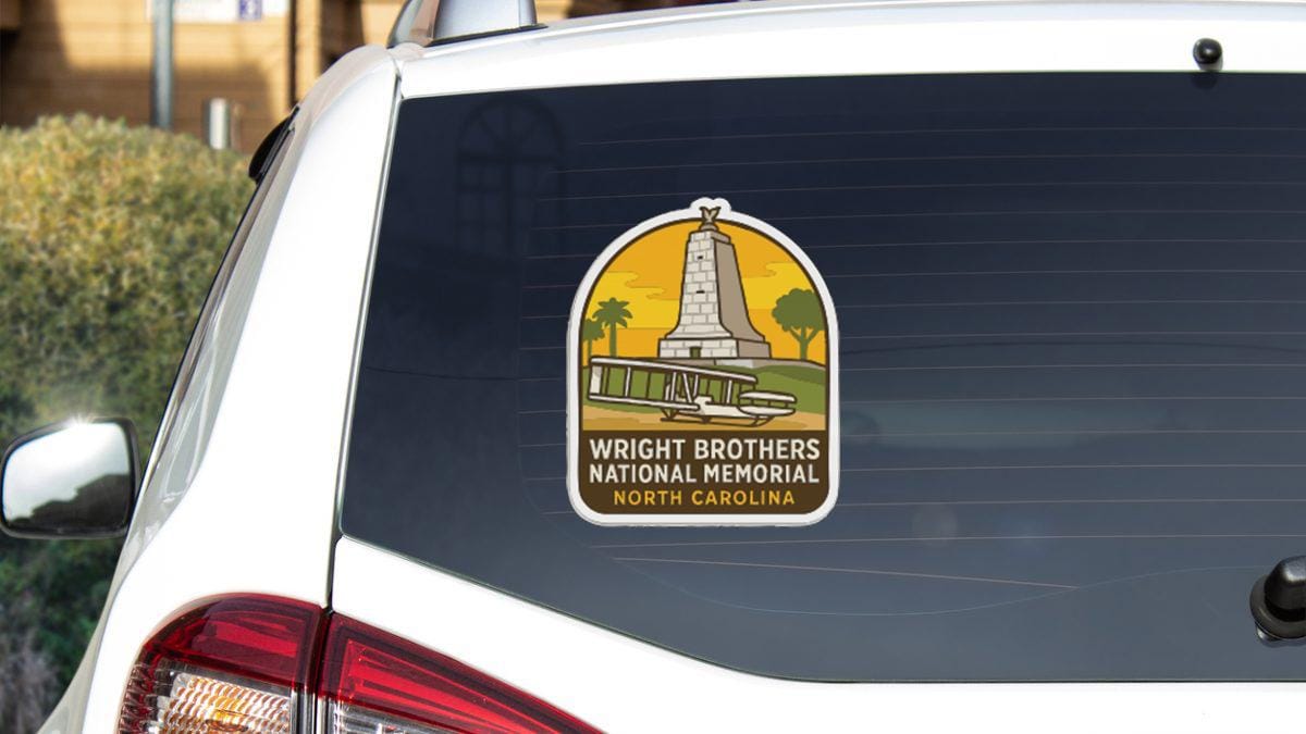 a sticker on the rear window of a vehicle, depicting a monument or memorial.