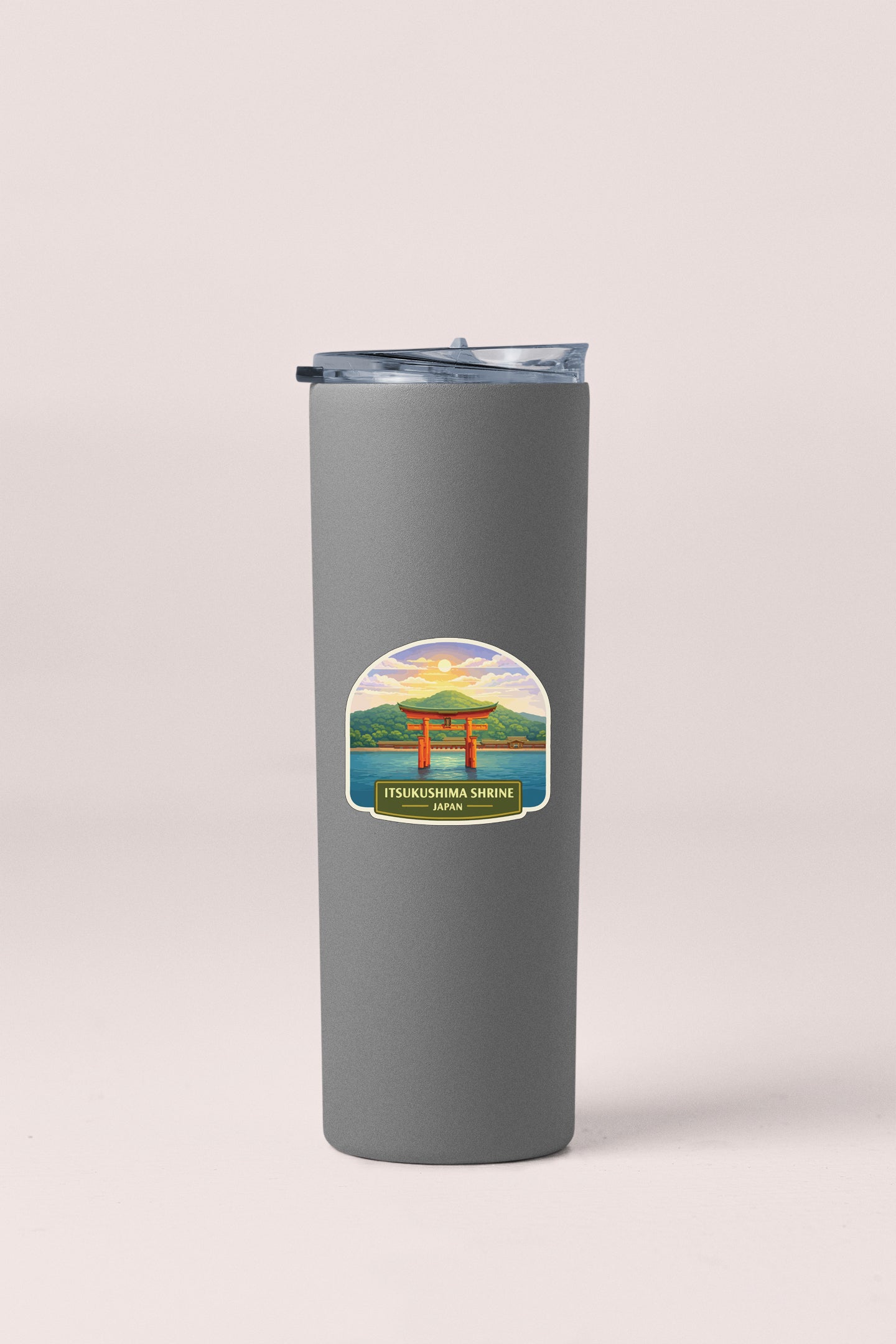 A gray cylindrical container with a lid and a label featuring an illustration of a temple and a sunset.