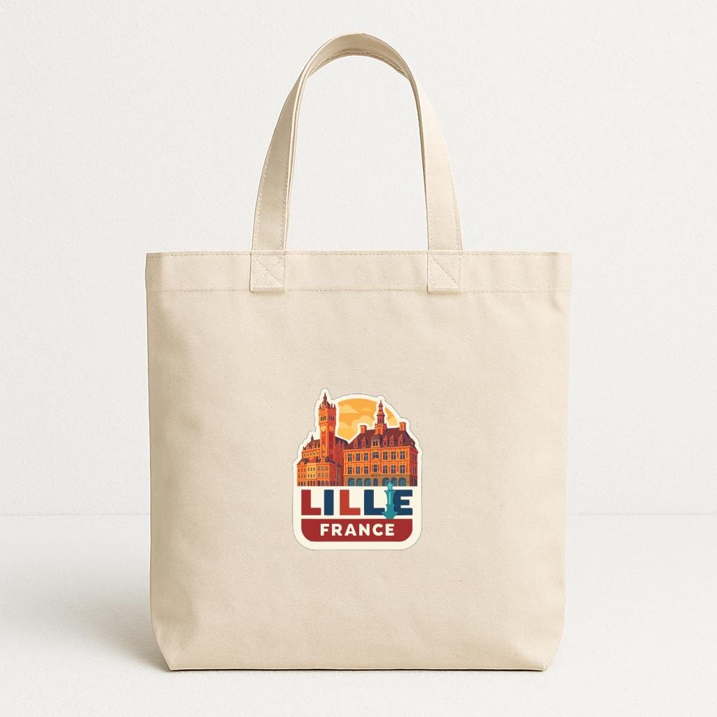 A beige tote bag with a graphic design featuring a cityscape and the text "LILLE FRANCE" printed on it.