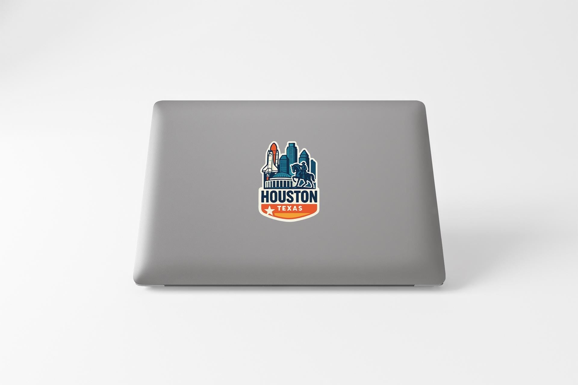 a laptop with a sticker of a city skyline