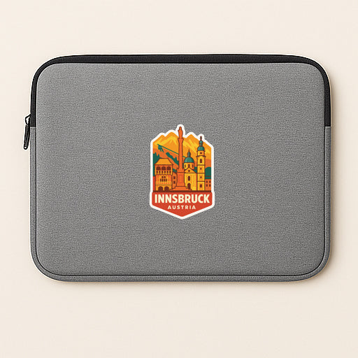 A gray laptop sleeve with a sticker of the city of Innsbruck, Austria.