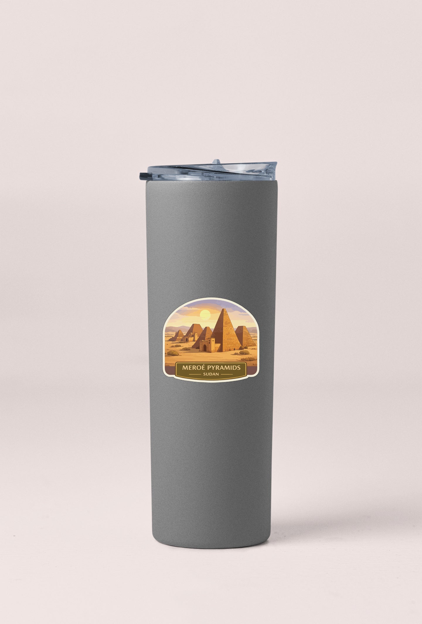 A gray cylindrical container with a lid and a label featuring an illustration of the Meroe Pyramids in Egypt.