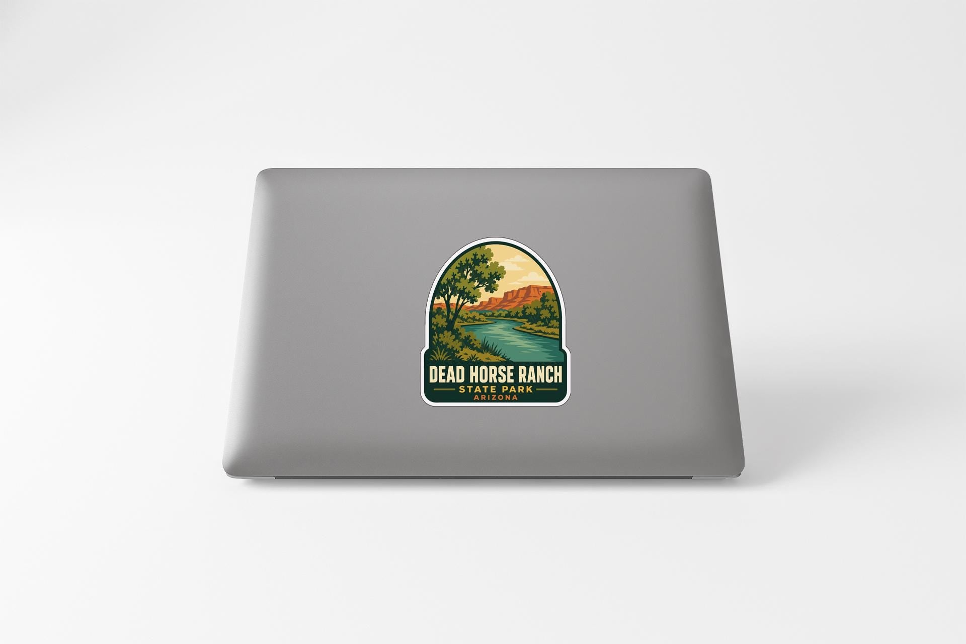 a sticker with a scenic landscape of a river and mountains, along with the text "DEAD HORSE RANCH STATE PARK".