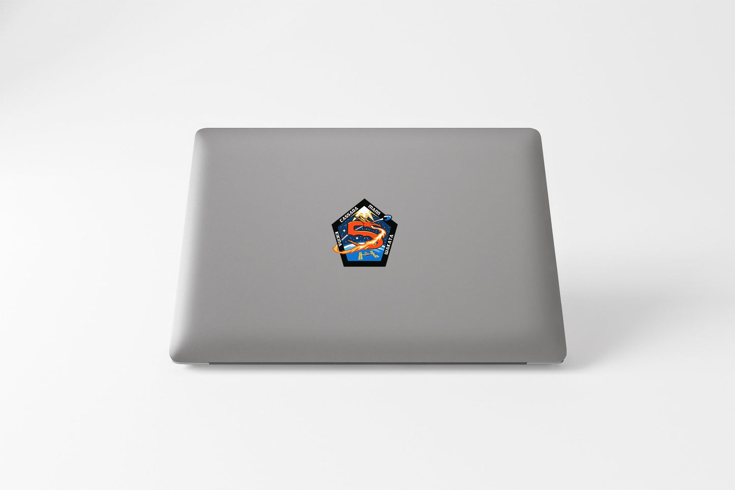 a laptop with a sticker of a house on it