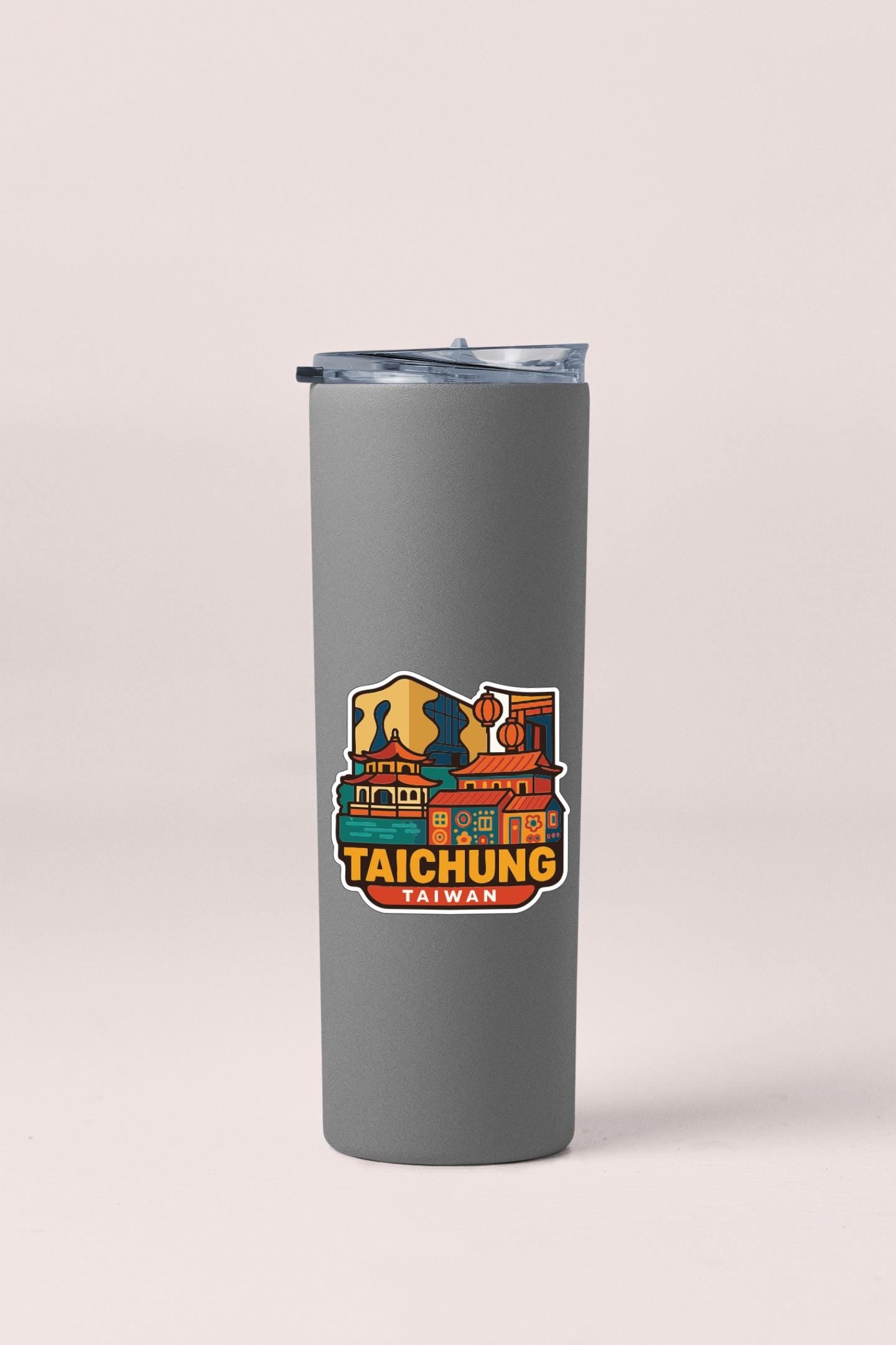 A gray insulated tumbler with a colorful sticker depicting a cityscape of Taipei, Taiwan.