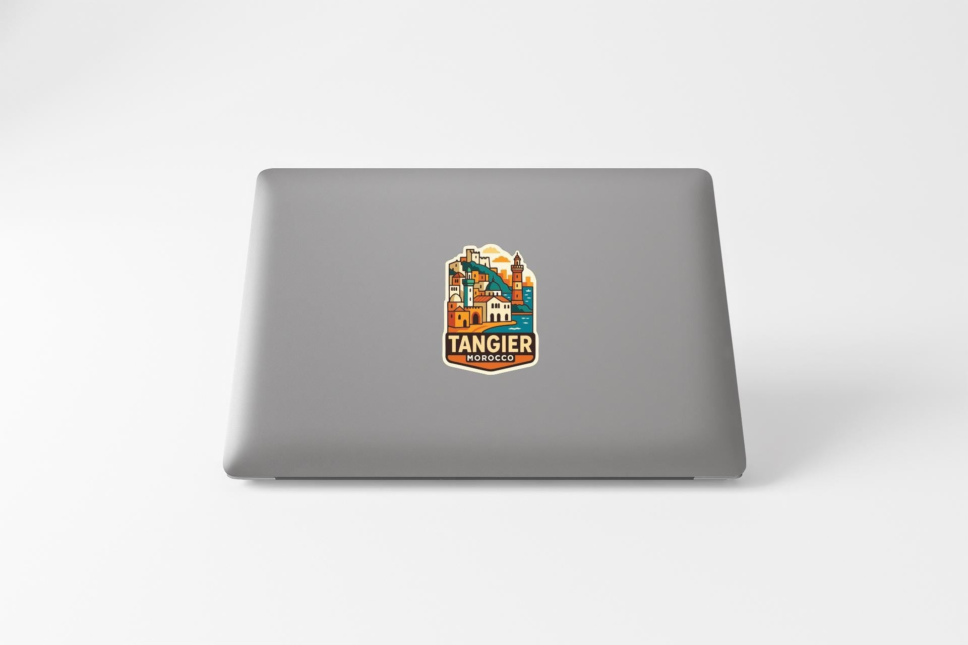 A sticker with a colorful illustration of a cityscape on a laptop.