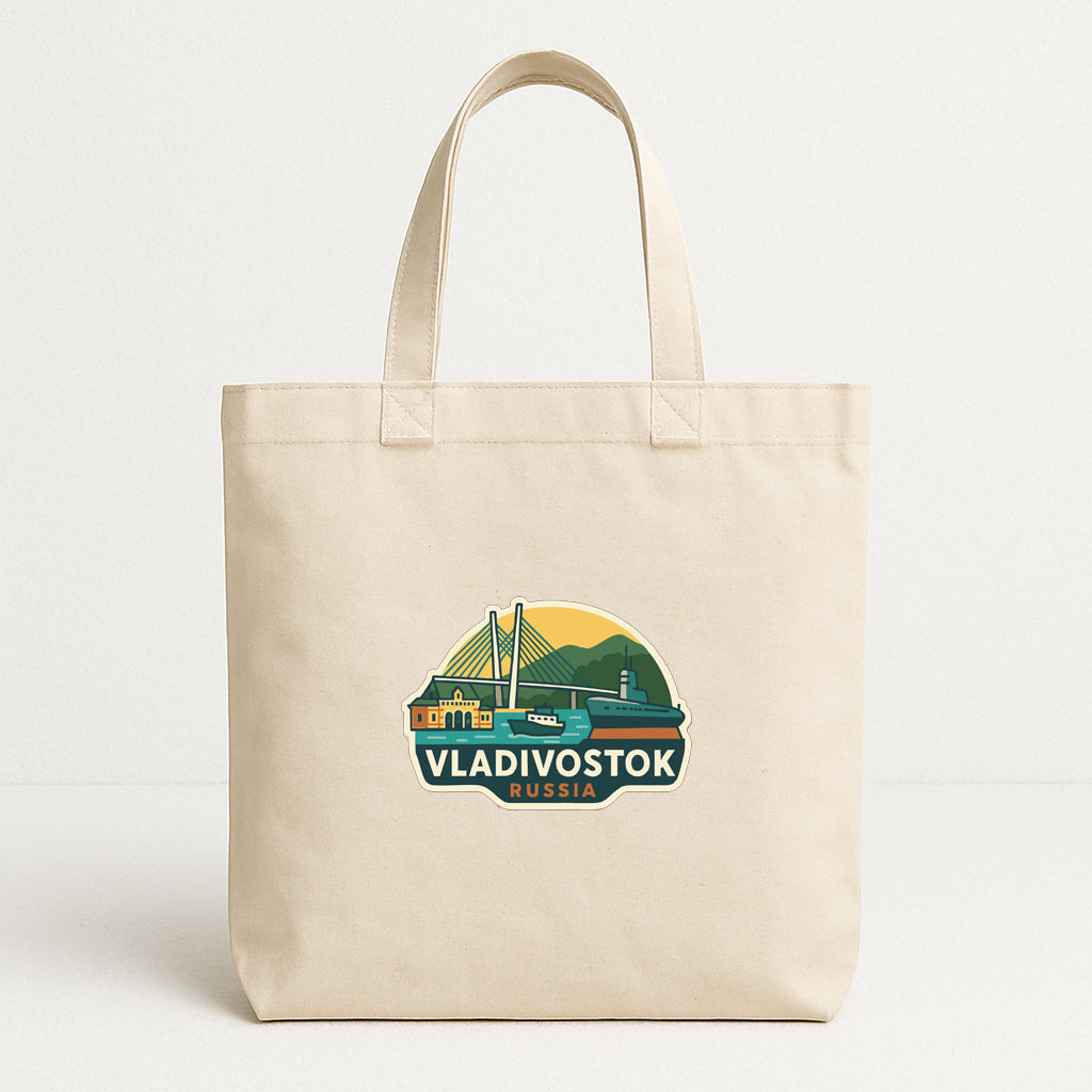 A beige tote bag with a graphic design depicting a bridge and mountains, along with the text "VLADIVOSTOK RUSSIA".