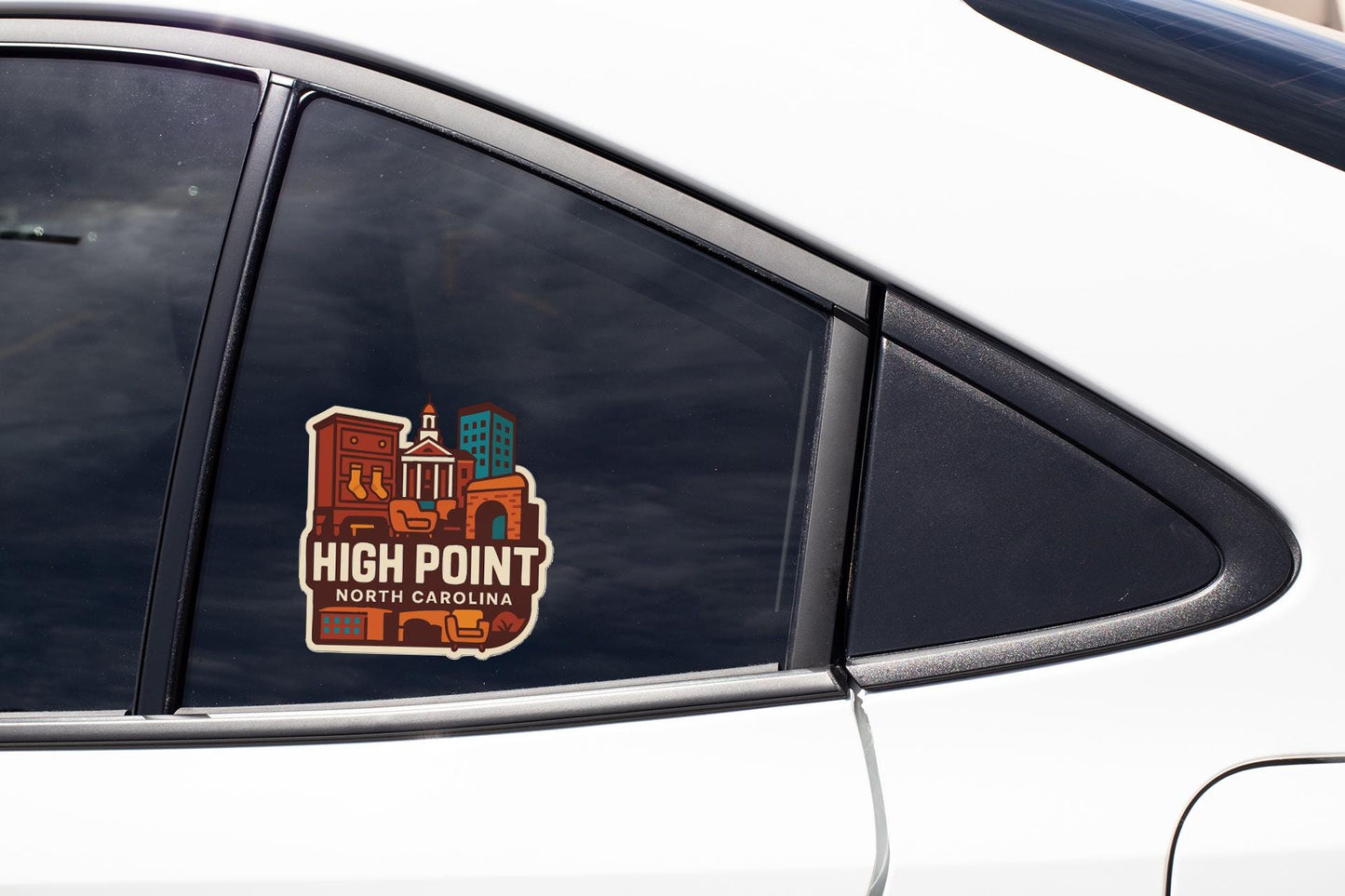 A sticker on the side of a car window, depicting a cityscape with buildings and a clock tower.
