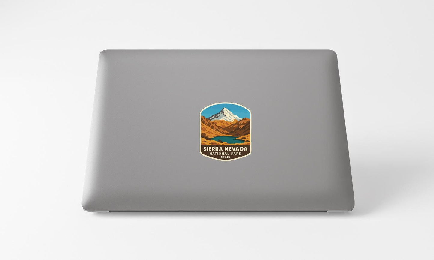 A sticker on the back of a laptop displaying the text "Sierra Nevada National Park" and an illustration of a mountain landscape.