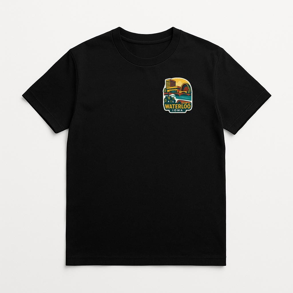 A black t-shirt with a colorful graphic on the front, depicting a yellow and green design with the text "WATERLOO" and "IOWA".