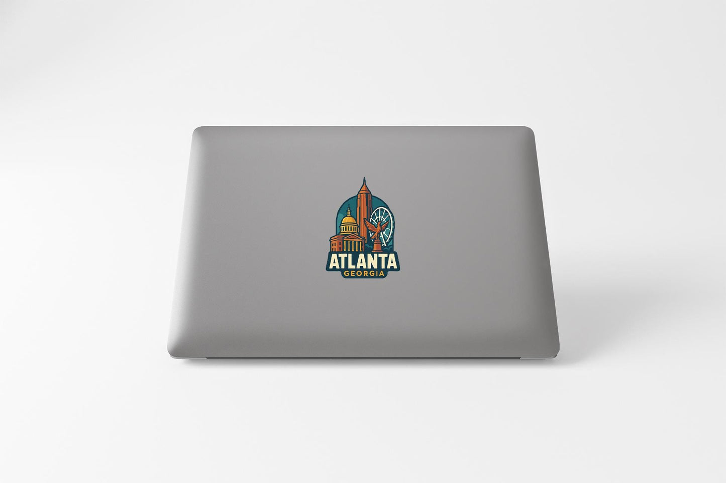 a laptop with a sticker of a space shuttle on it