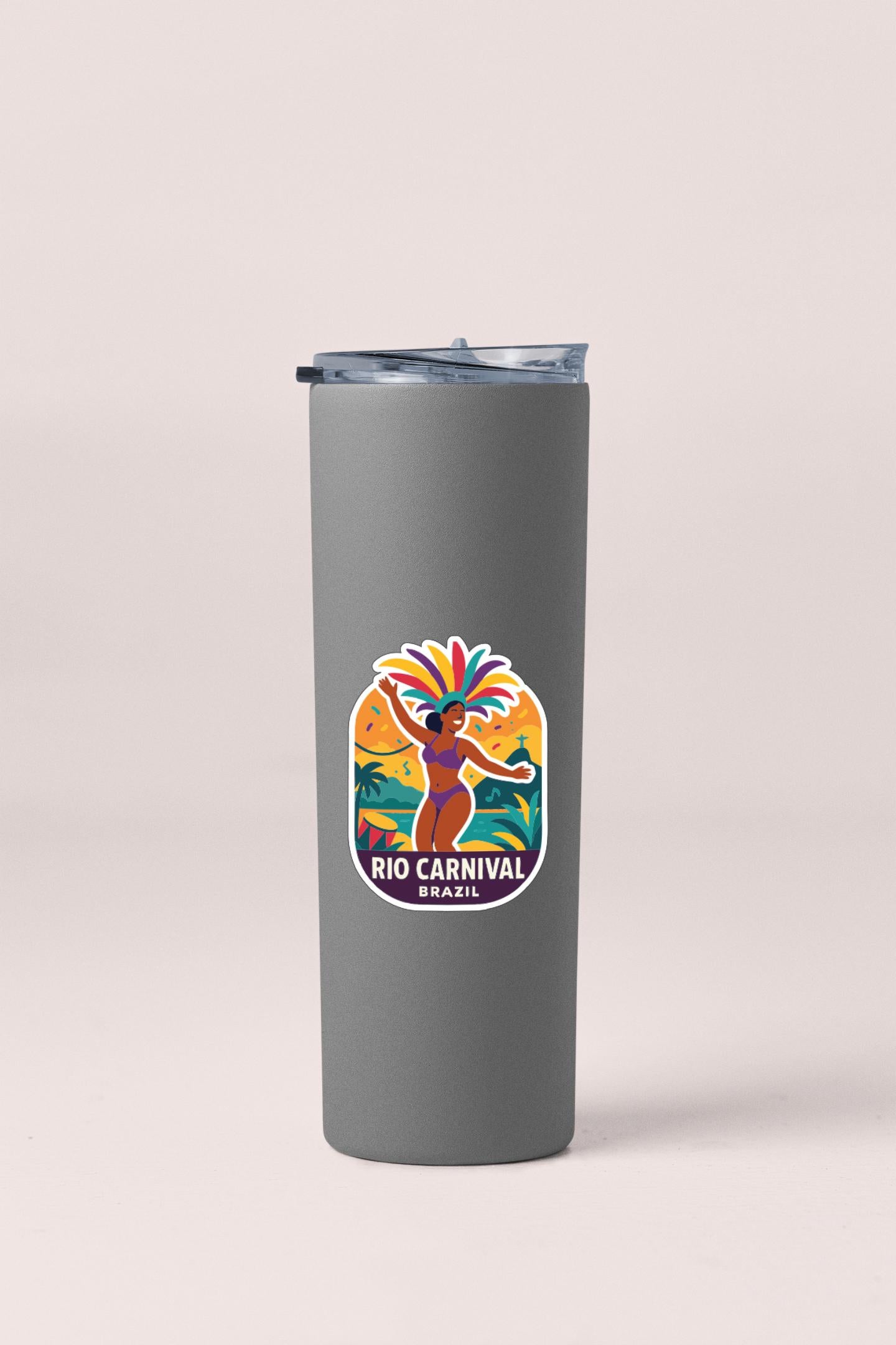A gray tumbler with a colorful sticker depicting a person in a carnival costume.
