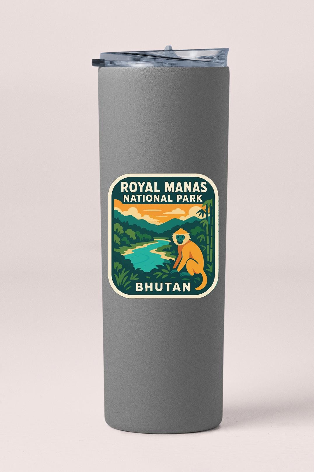 A gray cylindrical container with a label that says "Royal Manas National Park Bhutan" and features an illustration of a monkey in a lush, tropical setting.