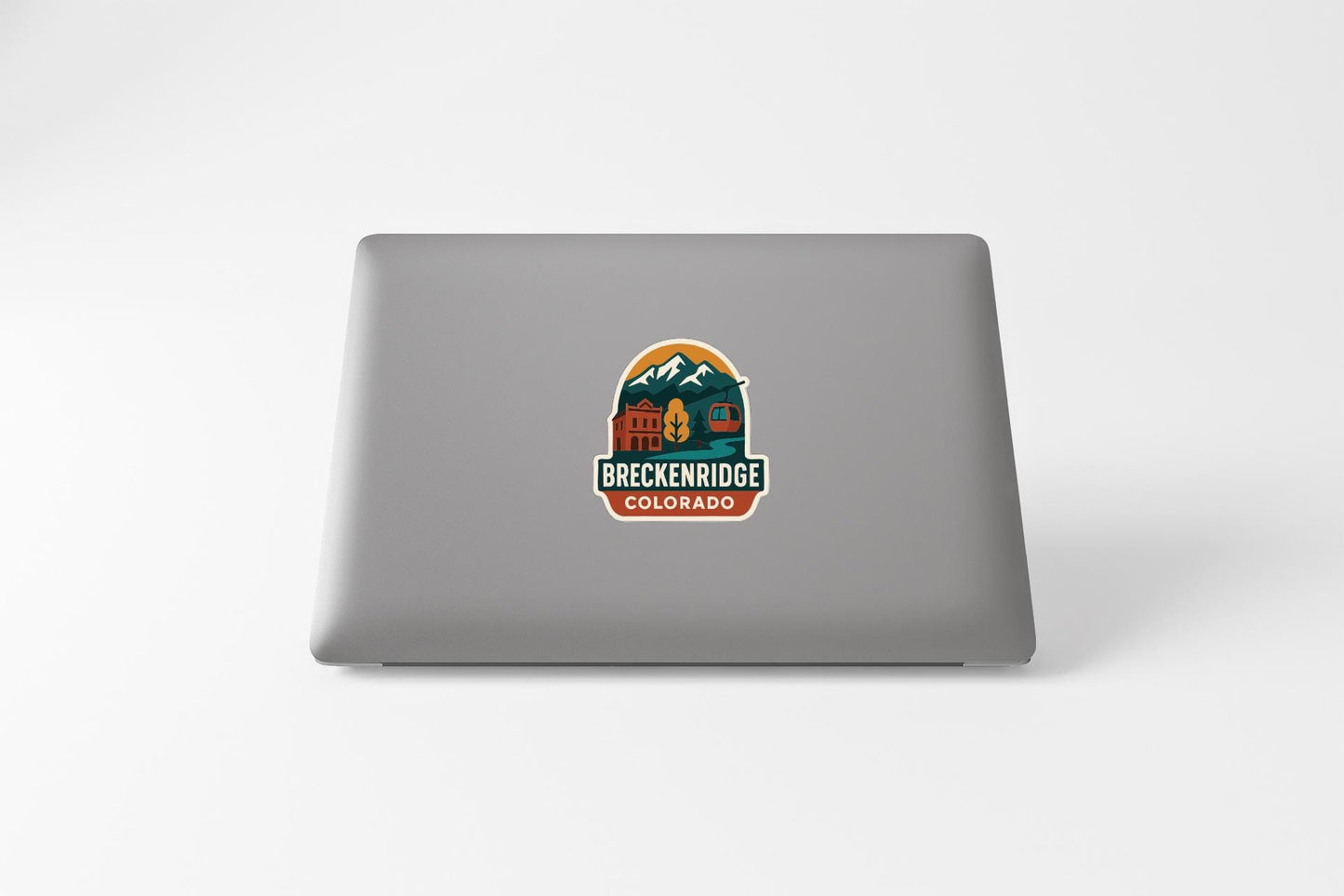 a sticker on the back of a laptop that says "BREKKENRIDGE COLORADO".