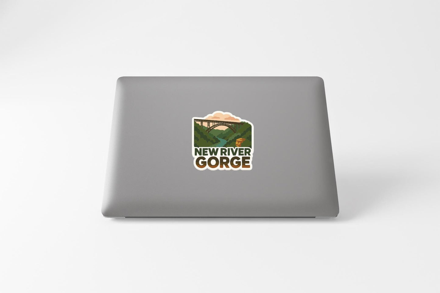 a sticker on the back of a laptop that says "NEW RIVER GORGE".
