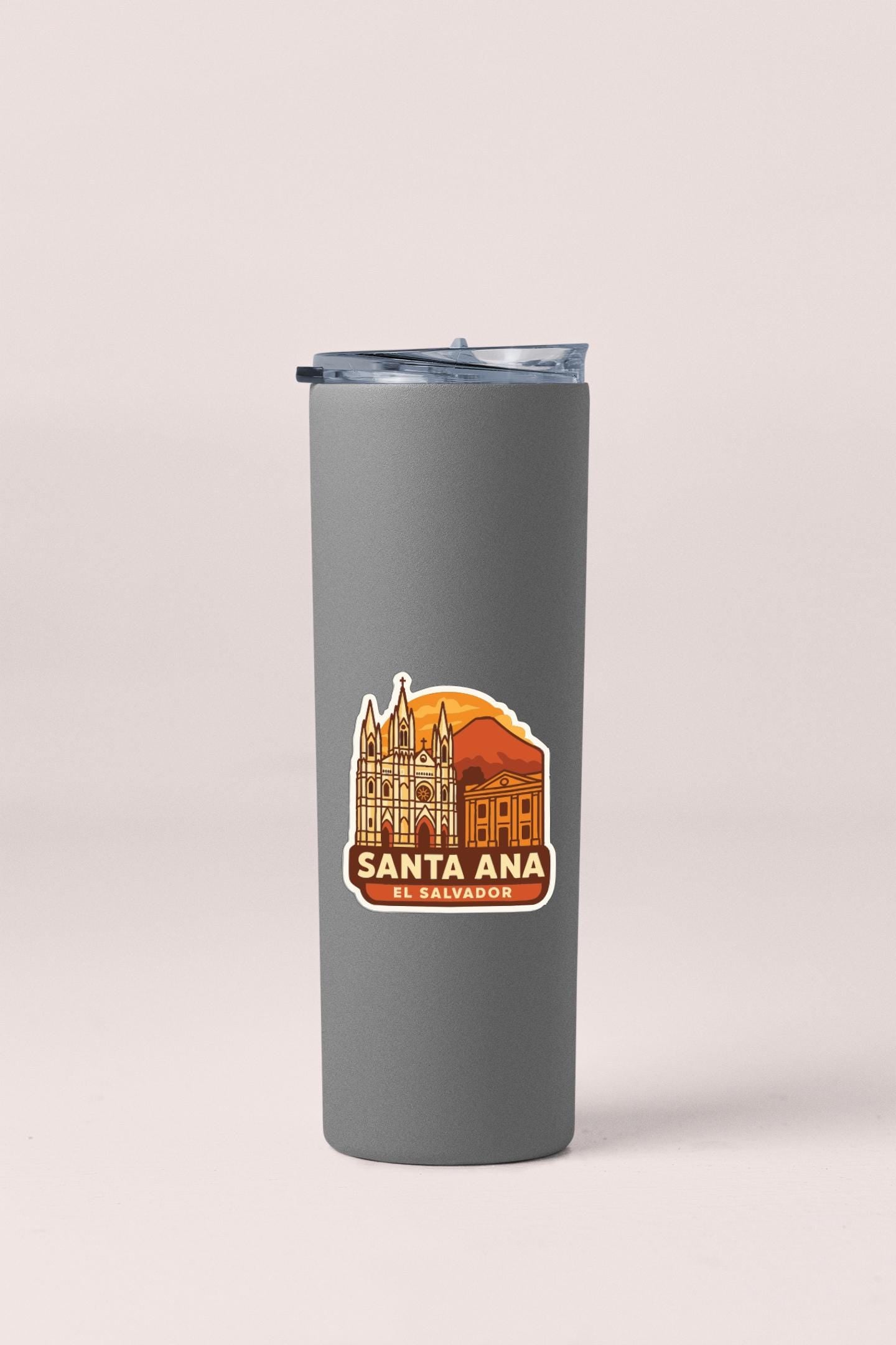 A gray insulated tumbler with a sticker depicting the Santa Ana Cathedral in the background.