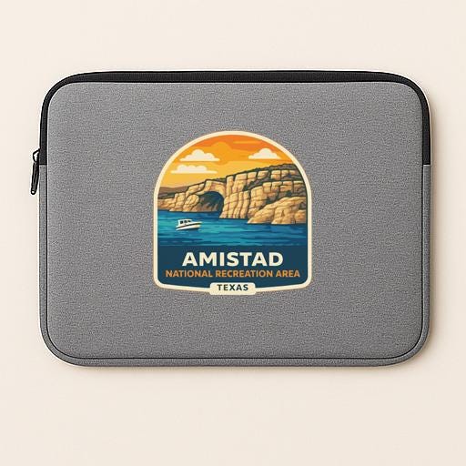 a gray laptop sleeve with a graphic design depicting a scenic landscape with a lake, mountains, and a boat.