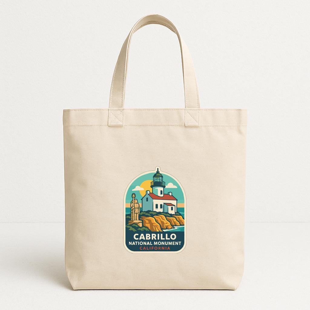 A beige tote bag with a printed design depicting the Cabrillo National Monument in California.