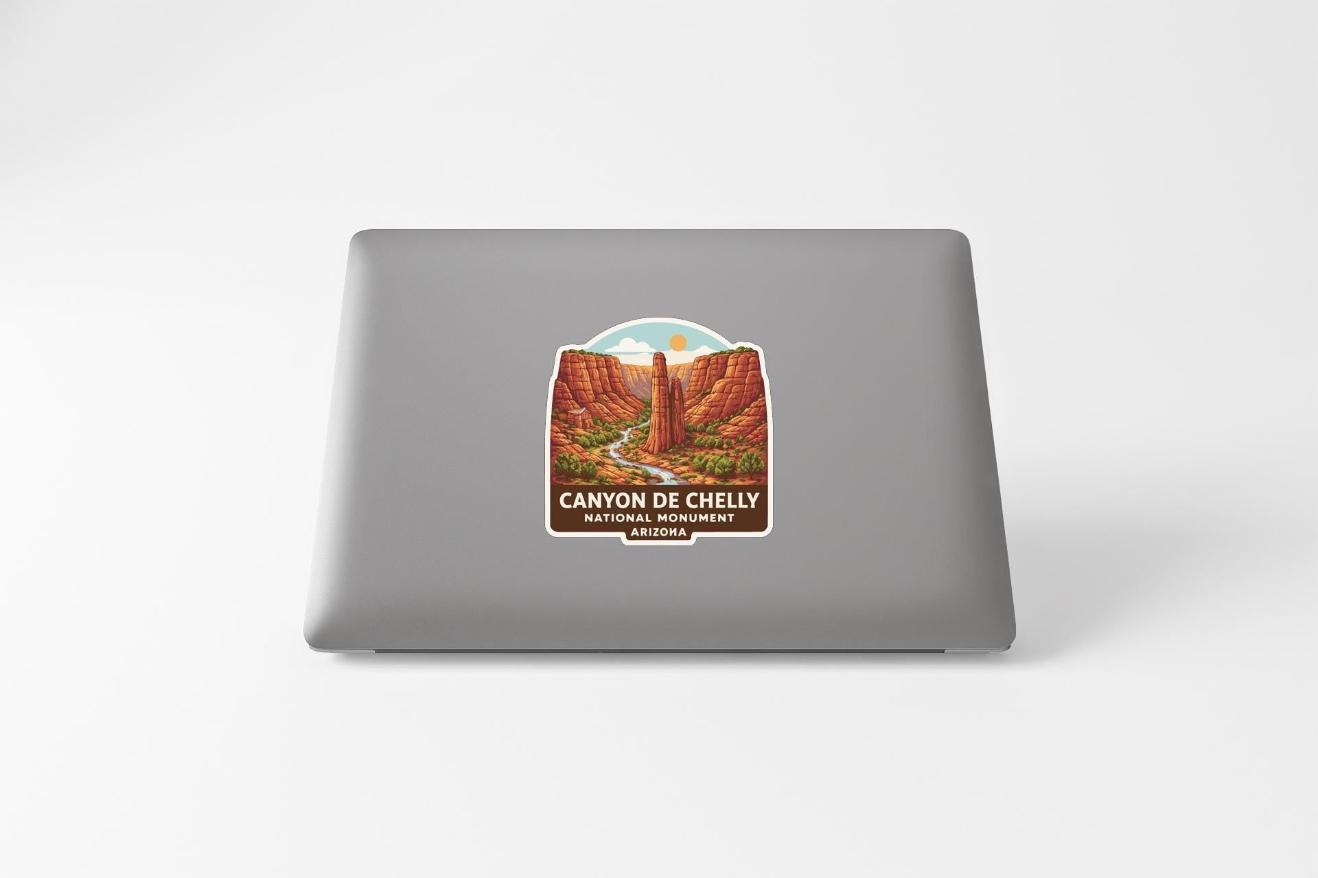 a sticker or label with a scenic illustration of a canyon or mountain range, along with the text "CANYON DE CHEEKY NATIVE PARK, ARIZONA".