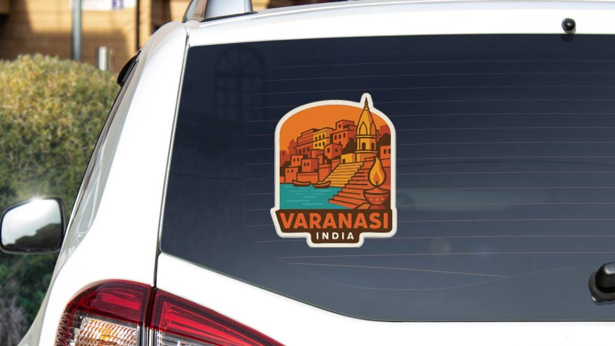 a sticker on the rear window of a white car, depicting a cityscape with a temple in the background.