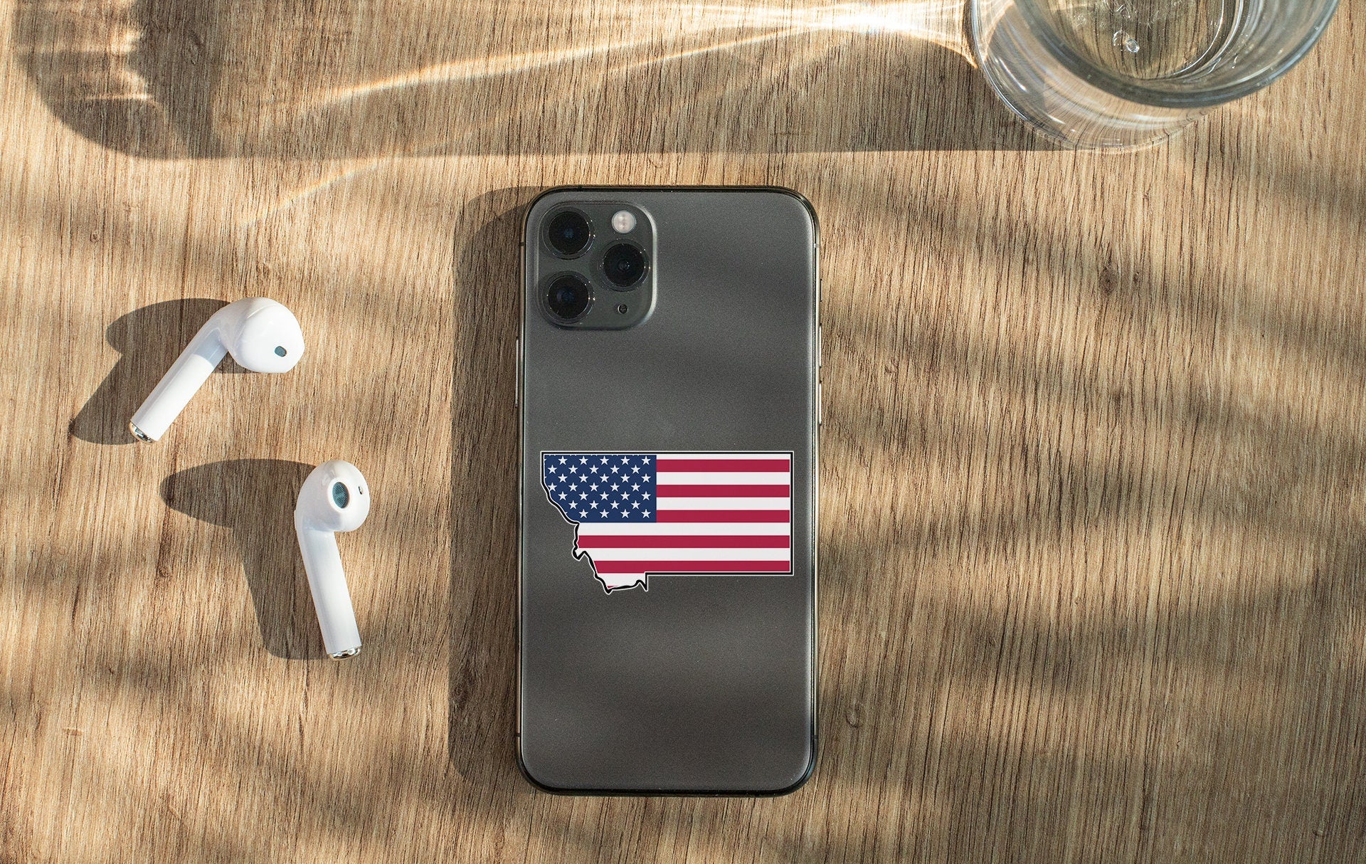a cell phone with a sticker of the state of texas on it