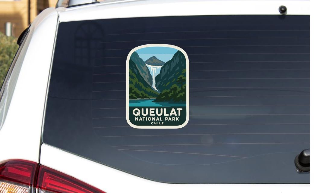 A sticker on the rear window of a car that says "Queuelat National Park Chile".