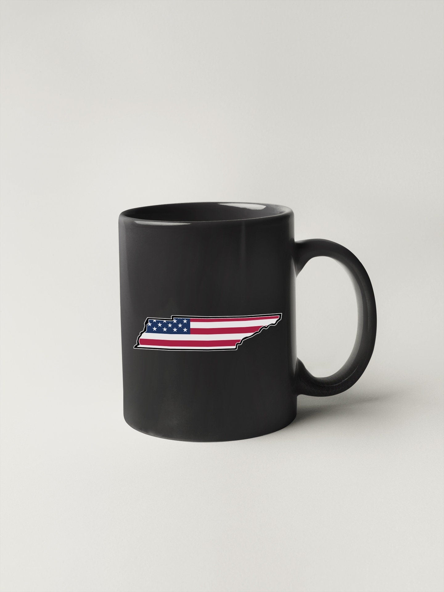 a black coffee mug with the american flag on it