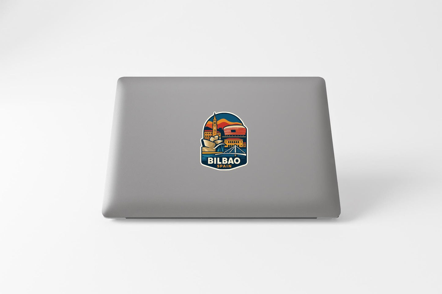 a sticker with a colorful illustration of a cityscape on the back of a laptop.