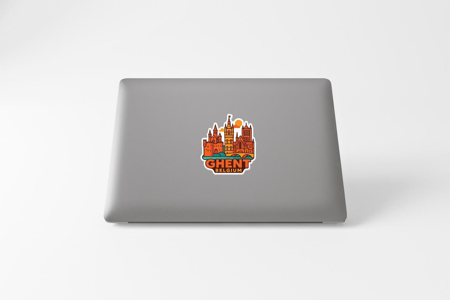 a sticker of a city skyline on the back of a laptop.
