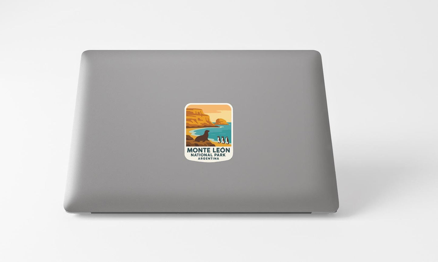 A sticker on the back of a laptop, depicting a scenic landscape with mountains, water, and a bird.
