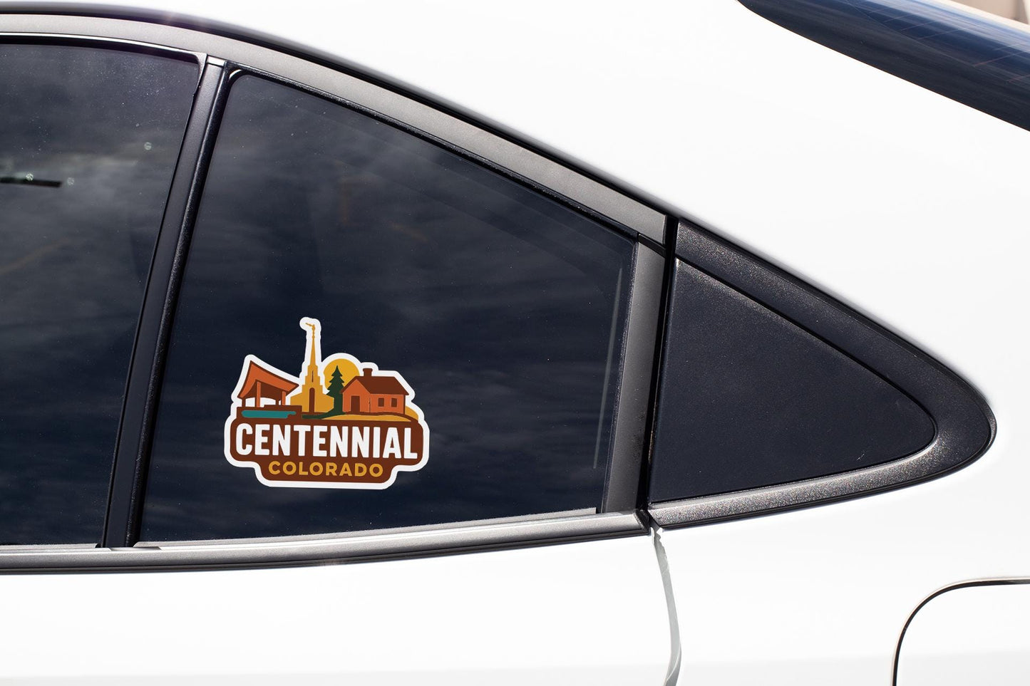 A close-up of a car window with a Centennial Colorado decal on it.