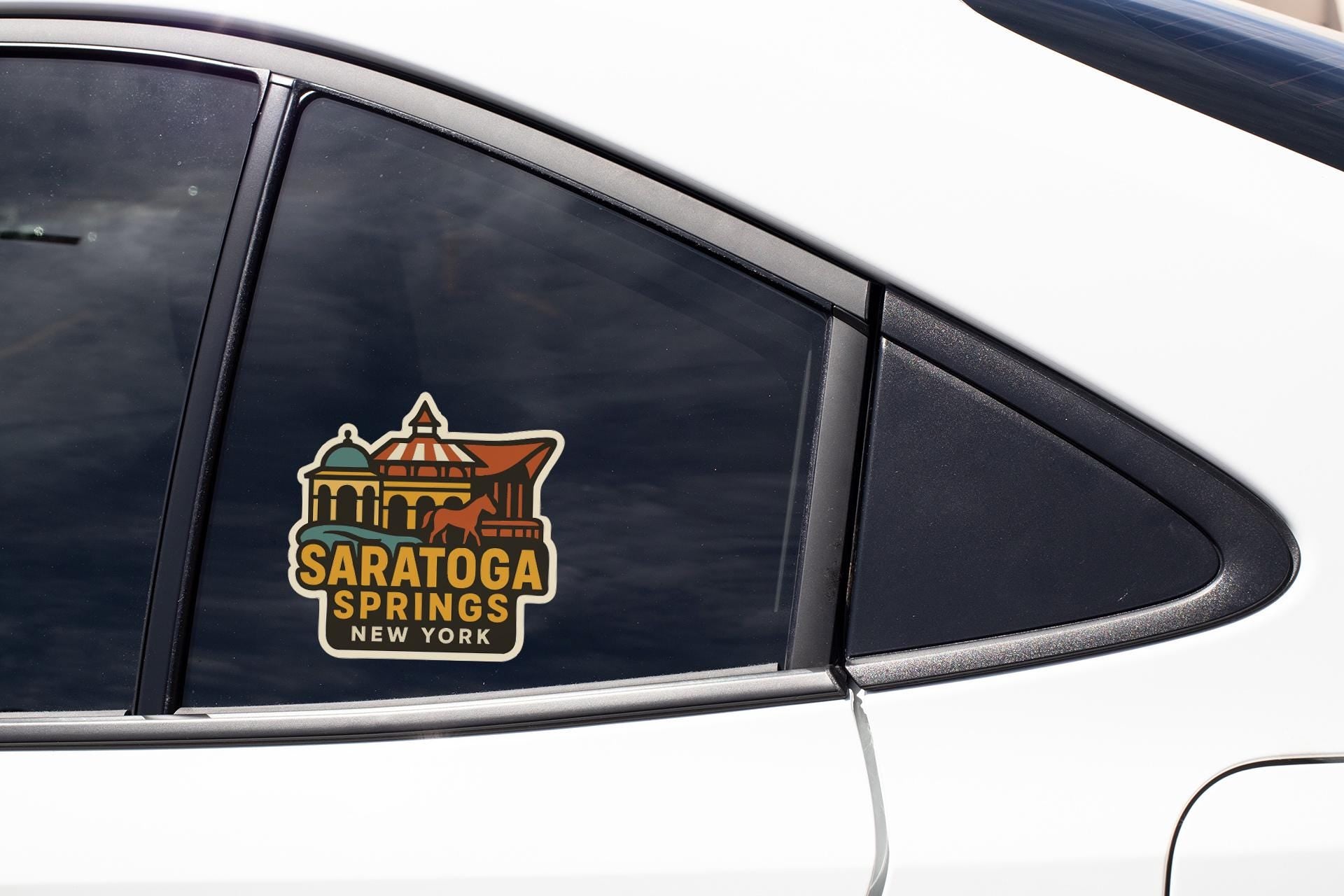 A car window with a sticker that says "Saratoga Springs, New York".