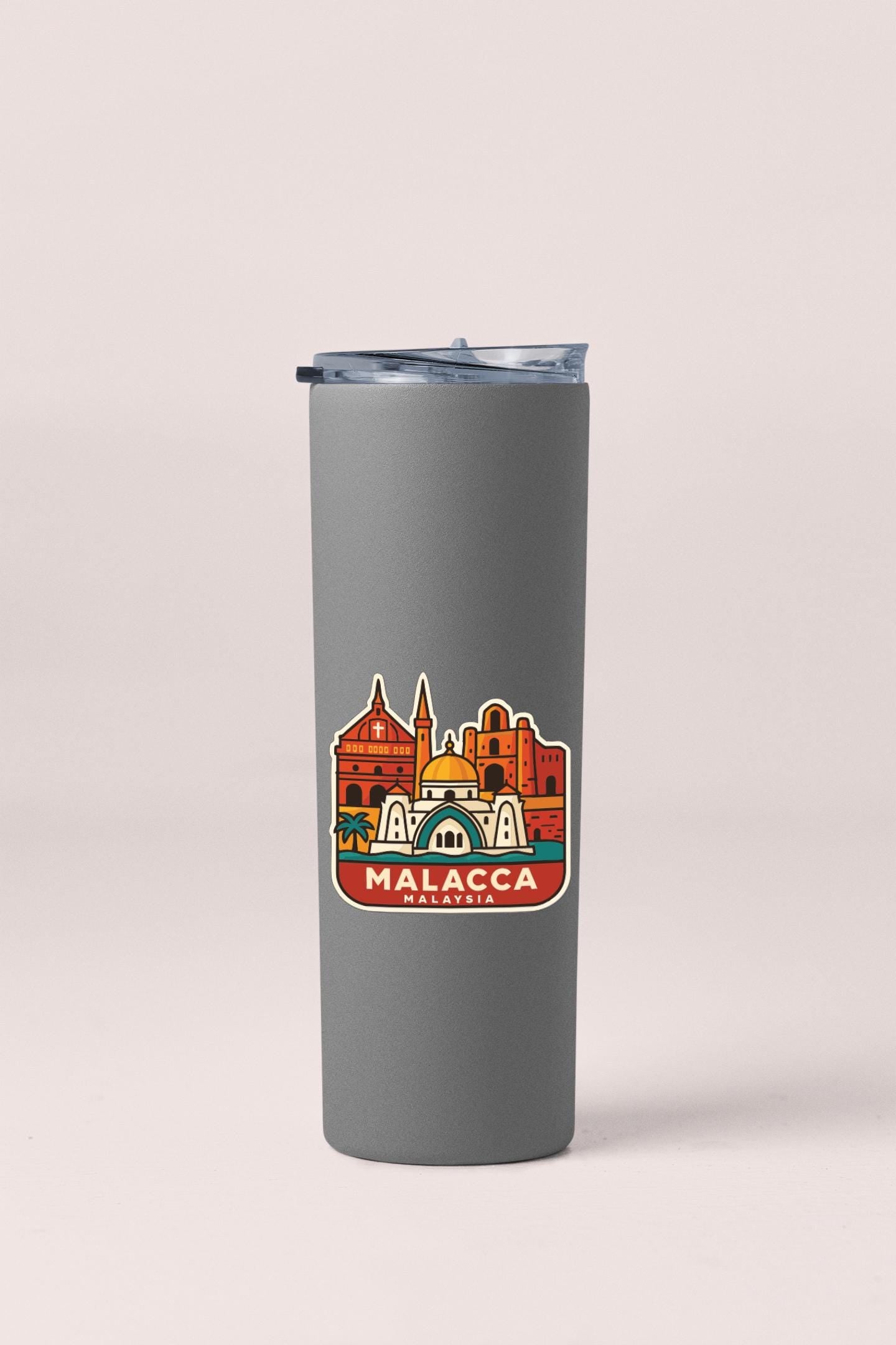 A gray insulated tumbler with a printed design of a city skyline and the text "MALACCMA" printed on it.